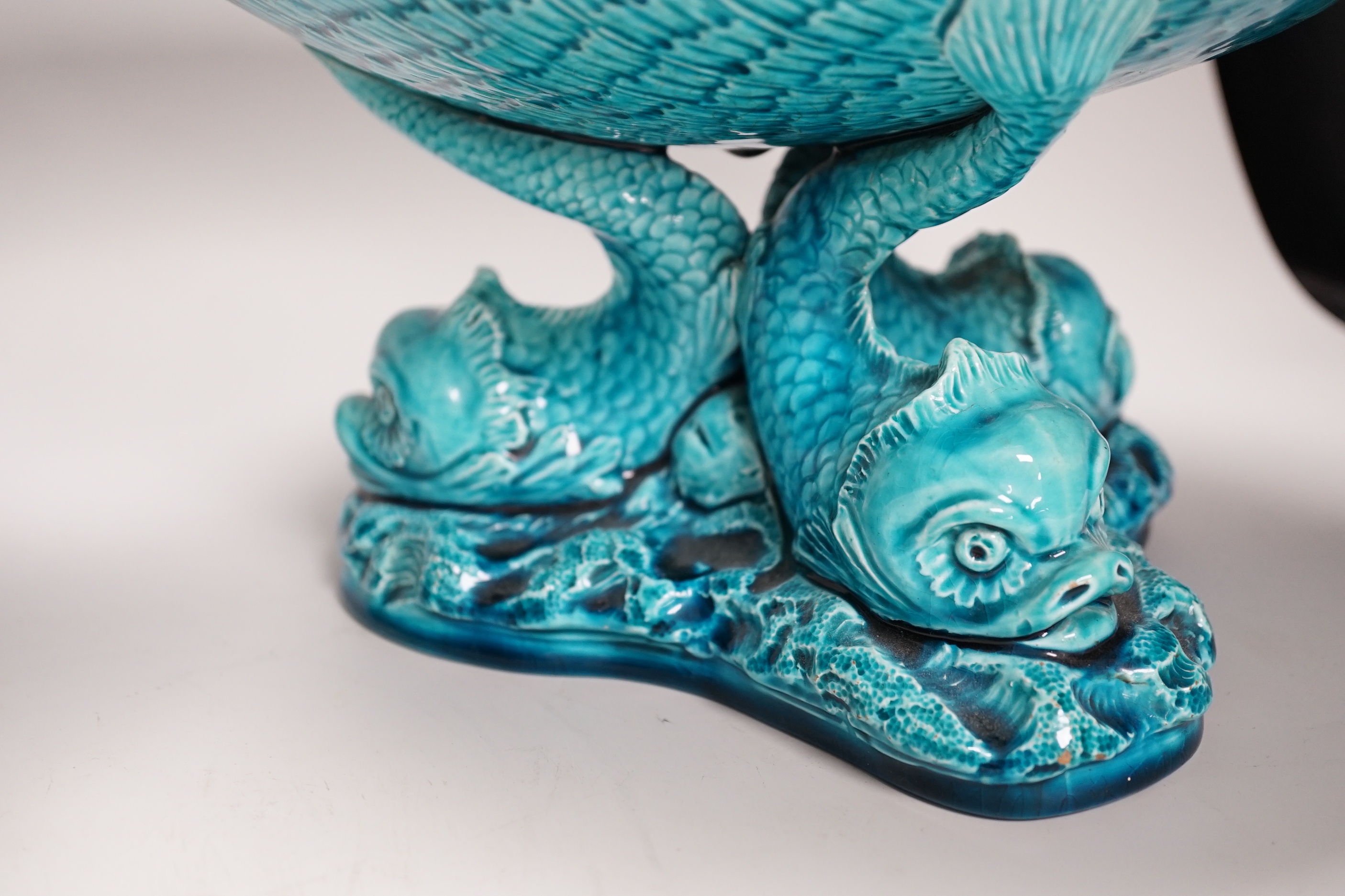 A pair of Burmantofts ‘dolphin’ pedestal bowls and a similar ‘dragon’ vase, 30cm